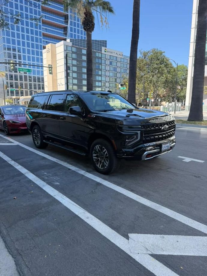 Black Elite Limo Chevy Suburban parked in downtown San Jose
